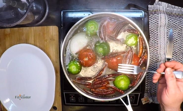 Boil the tomatoes, tomatillos, and onion
