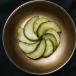 Din tai fung cucumber salad recipe result: marinated cucumber slices with sesame in a small metal bowl