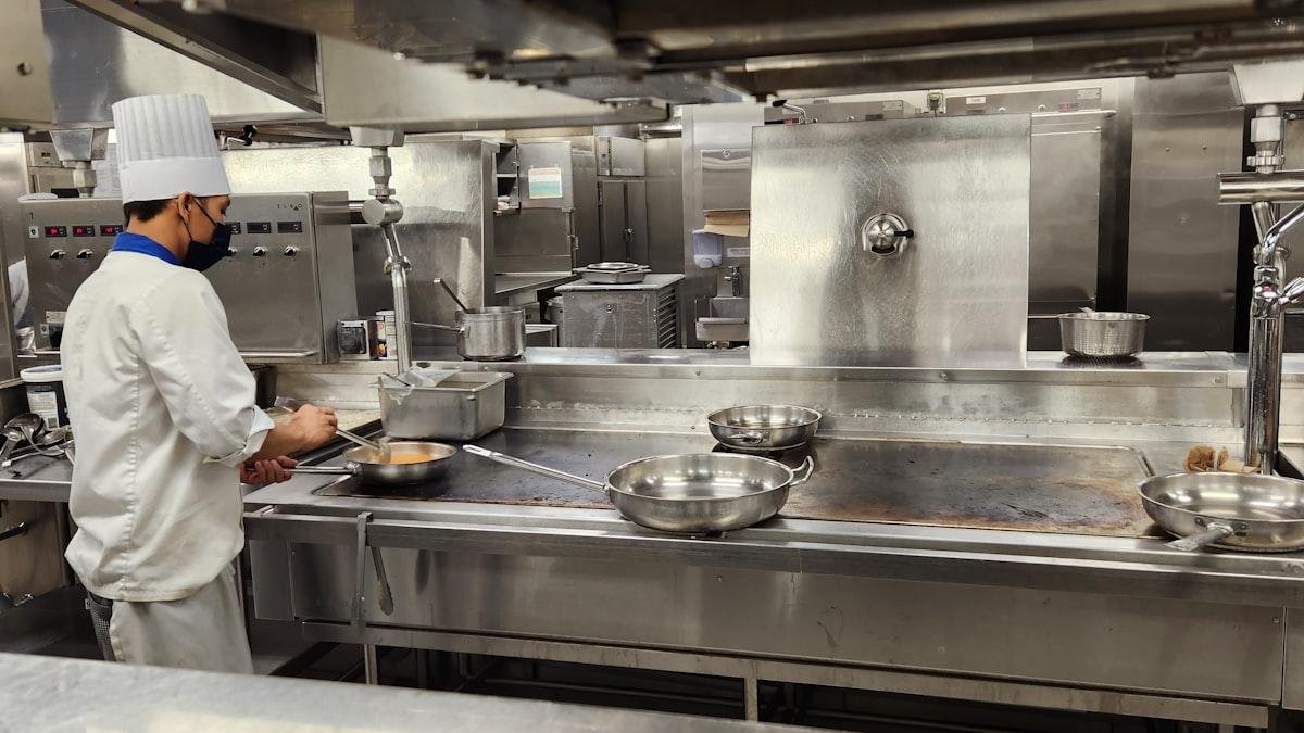 Chef working the line in a licensed commercial kitchen, the kind of space a commissary kitchen rents out