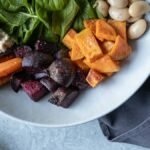Fall salads in one bowl: spinach, roasted sweet potato, beets, carrots and white beans with walnuts on the side