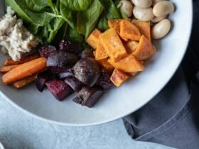 Fall salads in one bowl: spinach, roasted sweet potato, beets, carrots and white beans with walnuts on the side