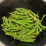 Din Tai Fung green beans recipe result: bright green garlic green beans tossed in a black wok