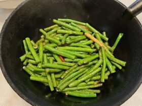 Din Tai Fung green beans recipe result: bright green garlic green beans tossed in a black wok