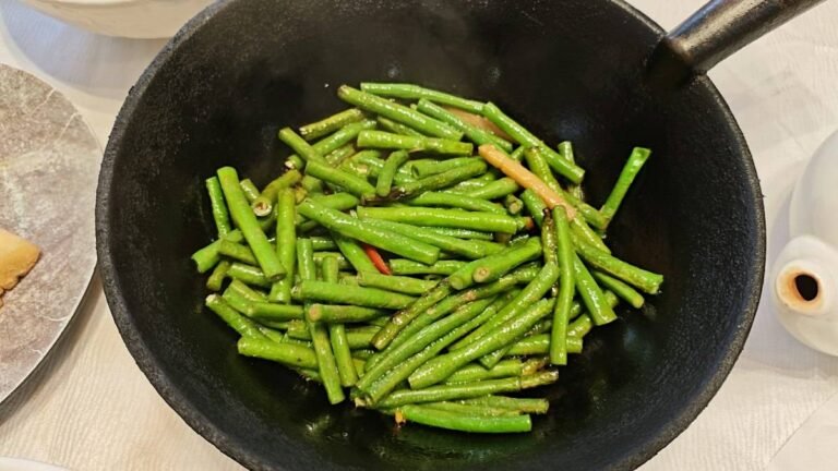 Din Tai Fung green beans recipe result: bright green garlic green beans tossed in a black wok