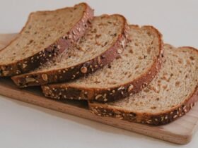 Outback Steakhouse bread recipe inspiration: slices of dark brown whole wheat bread fanned out on a wooden board