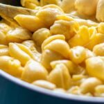Panera mac and cheese recipe at home: shell pasta in a creamy white cheddar sauce in a skillet