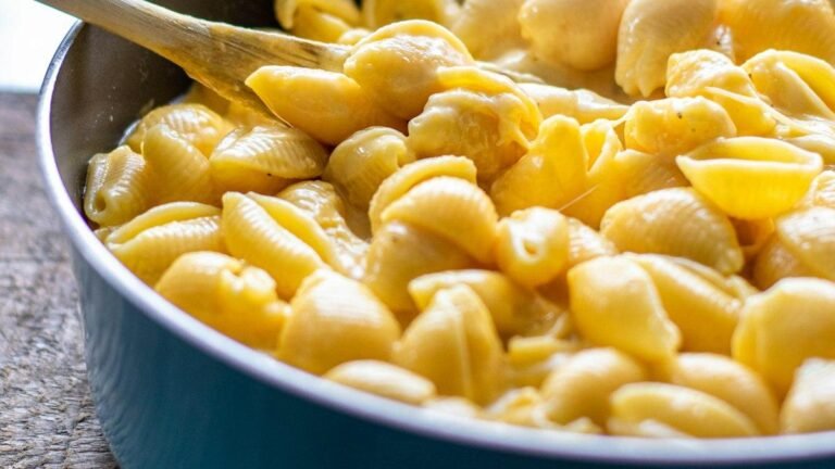 Panera mac and cheese recipe at home: shell pasta in a creamy white cheddar sauce in a skillet