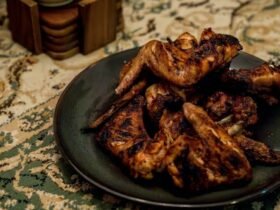Wingstop Louisiana rub recipe inspiration: crisp seasoned chicken wings piled on a dark plate